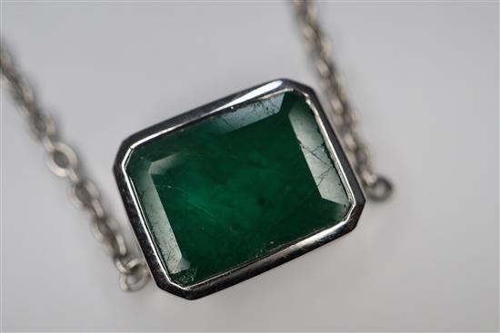 An 18ct white gold and solitaire emerald set pendant necklace, pendant 9mm.